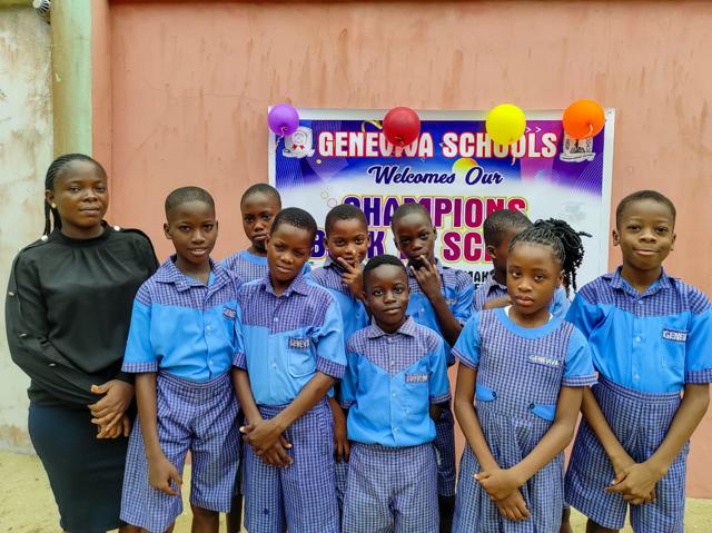 Primary pupils in blue uniforms with their teacher